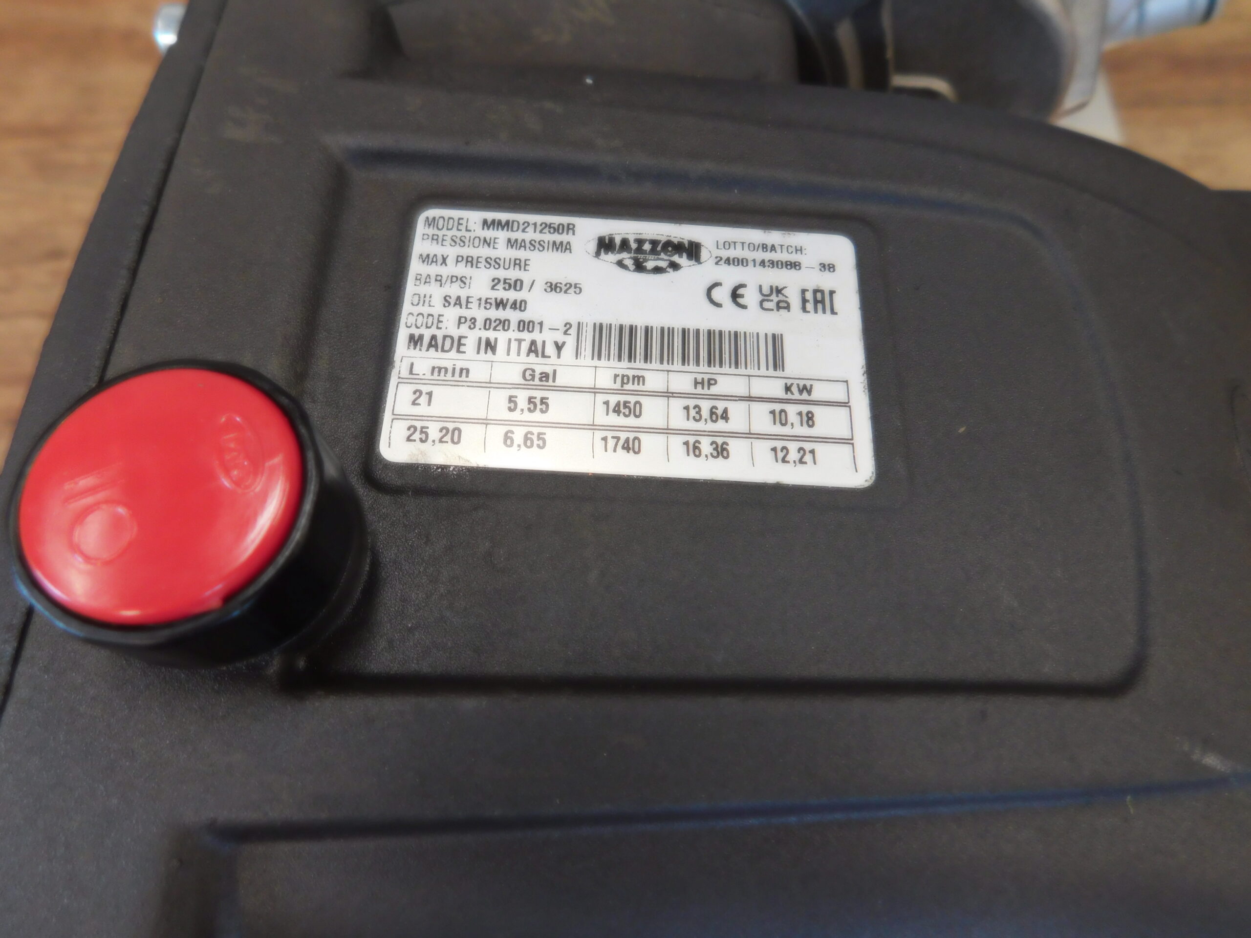 Black pump casing with red cap and label